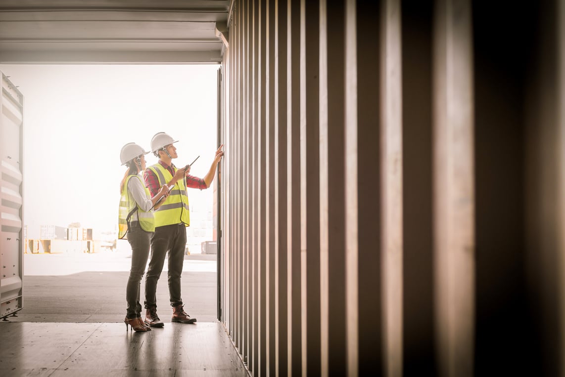 Staff Checking Container Box in Shipping Yard